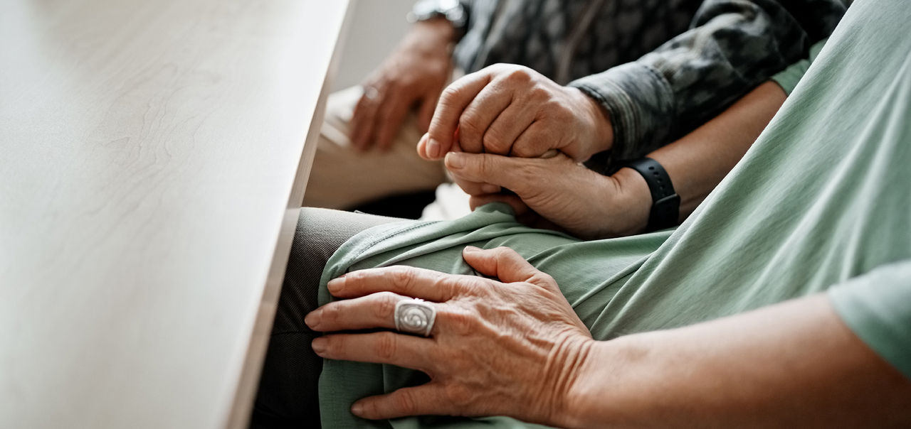 Two people holding hands