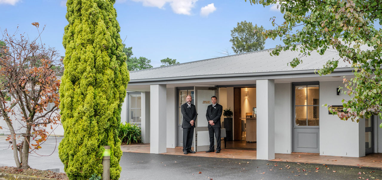 Le Pine funeral directors standing in front of a funeral home